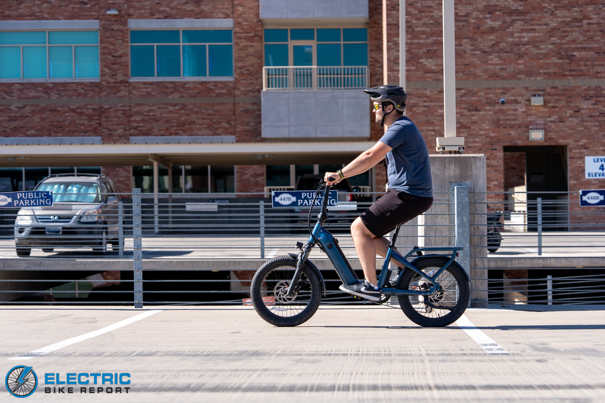 Man riding Ride1UP Portola E-Bike in a parking lot