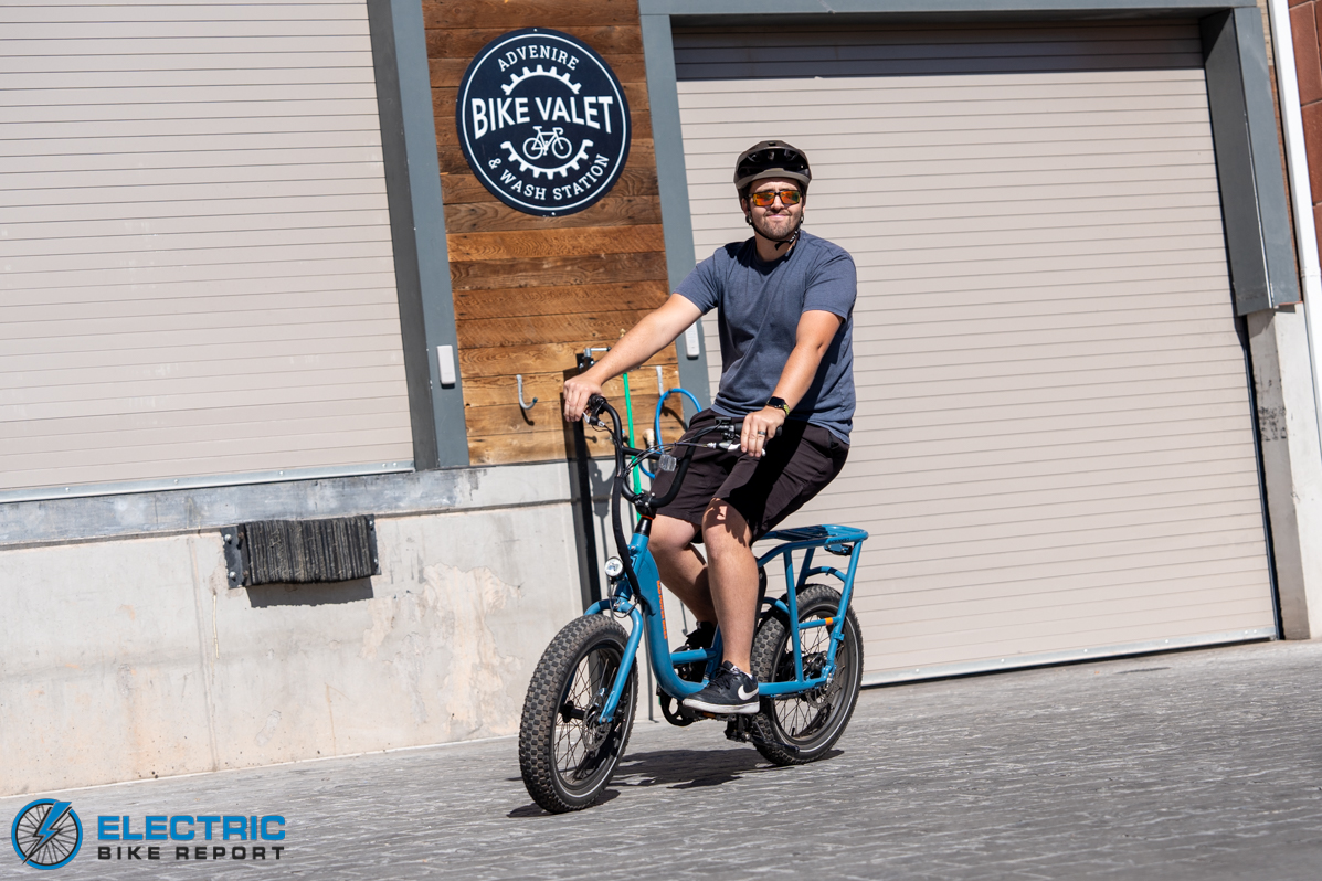 Man riding RadRunner 2 in front of industrial garage doors