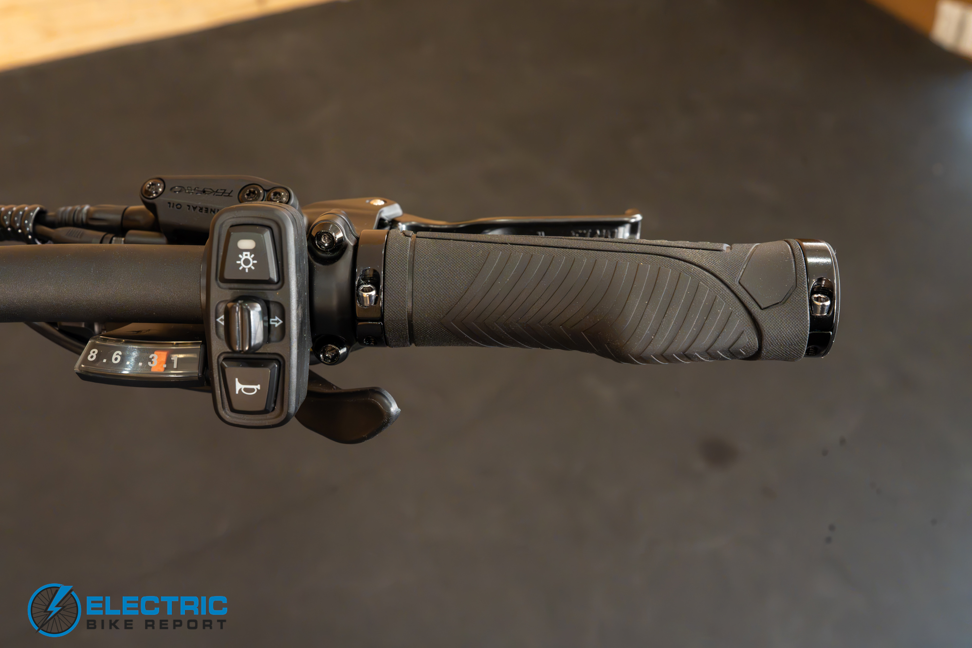 AIMA Key West 2.0 shifter and grip closeup showing handlebar controls