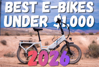 Electric white e-bike in a desert landscape with bold overlay text: 'Best E-Bikes Under $1,000 2026'