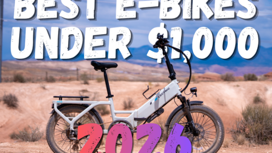 Electric white e-bike in a desert landscape with bold overlay text: 'Best E-Bikes Under $1,000 2026'