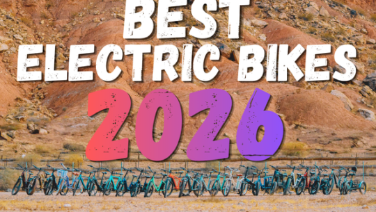 Banner reading "Best Electric Bikes 2026" with colorful 2026 typography above a row of electric bikes parked in a desert landscape.