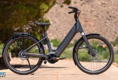 All-gray electric bike parked on a dirt path with a logo reading 'Electric Bike Report' bottom-left.