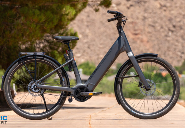 All-gray electric bike parked on a dirt path with a logo reading 'Electric Bike Report' bottom-left.