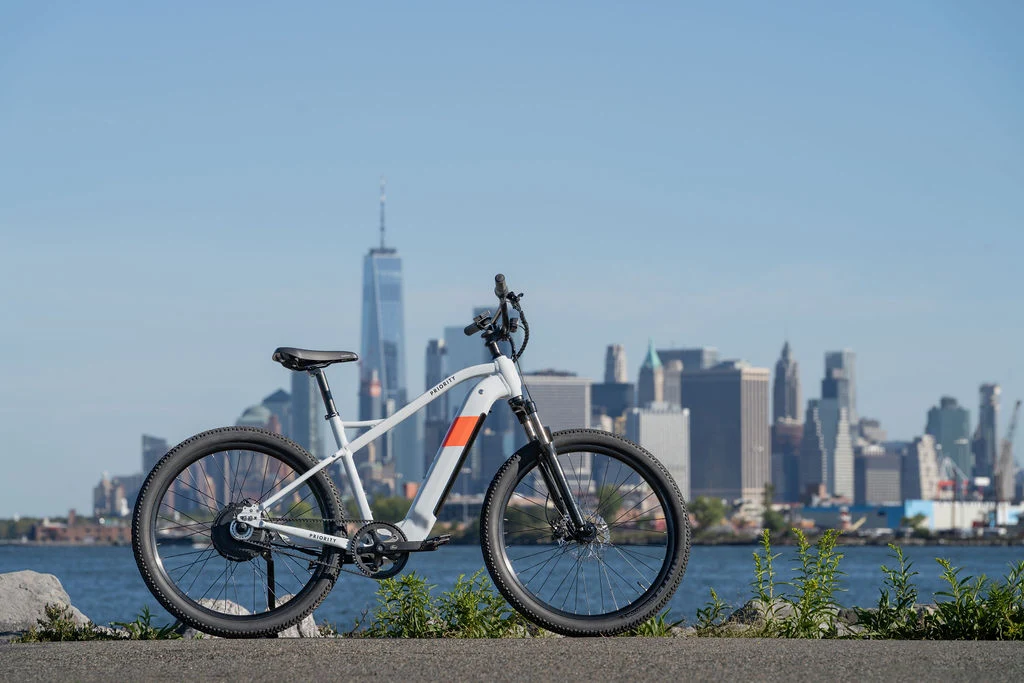 Priority Bicycles E-Sauce electric bike lifestyle shot featuring rider in outdoor setting