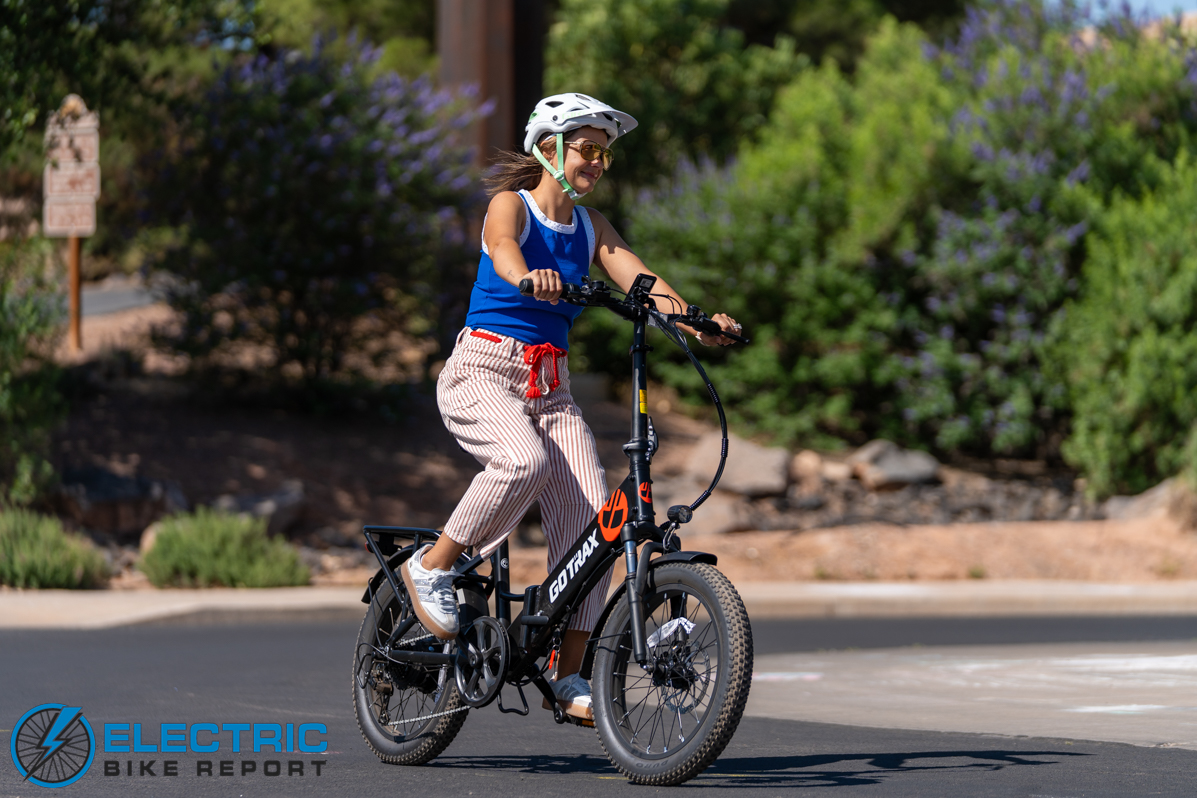 GoTrax F2 electric bike rider in action shot outdoor riding scene