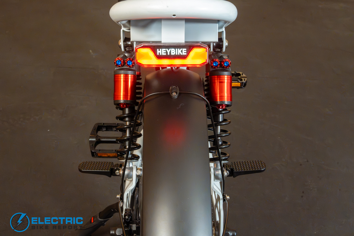 Heybike Titan white ebike rear taillight full suspension and pedals side view