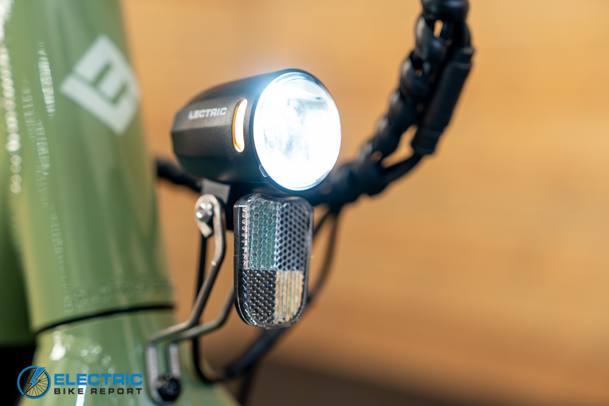 Lectric XPress Lite electric bike headlight illuminated during a ride