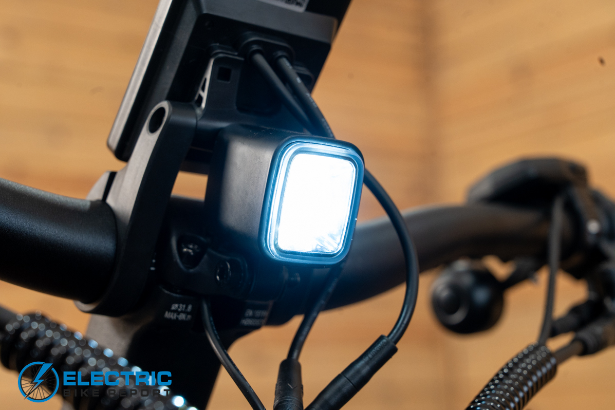 Urtopia Carbon Atom electric bike headlight illuminated during night riding